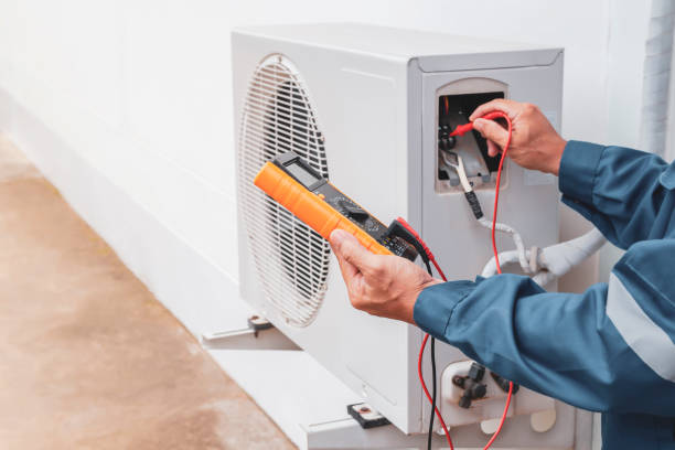 AC outdoor unit electrical testing by professional technician in Dubai